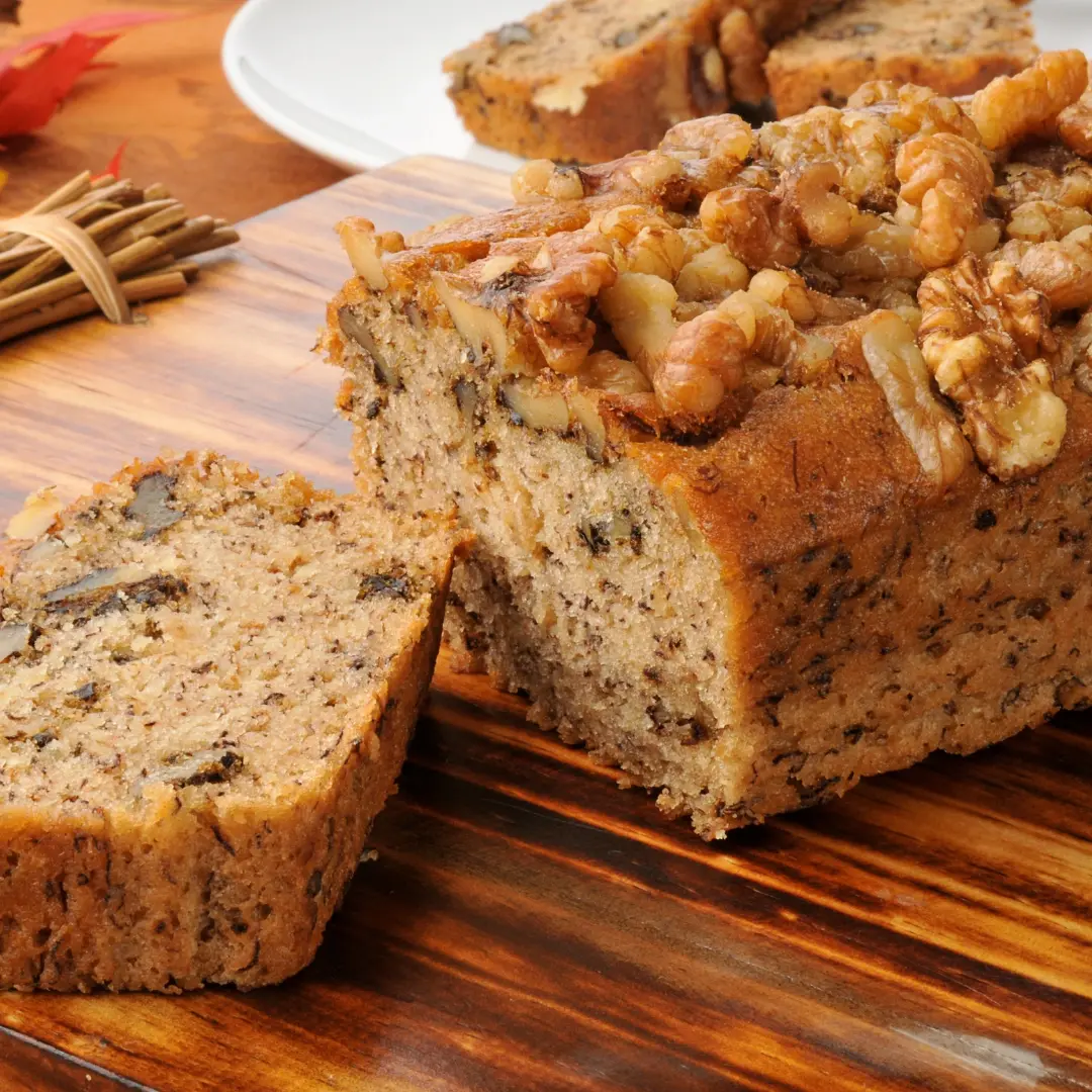 A bowl of banana bread batter made with banana bread mix and two ripe bananas.